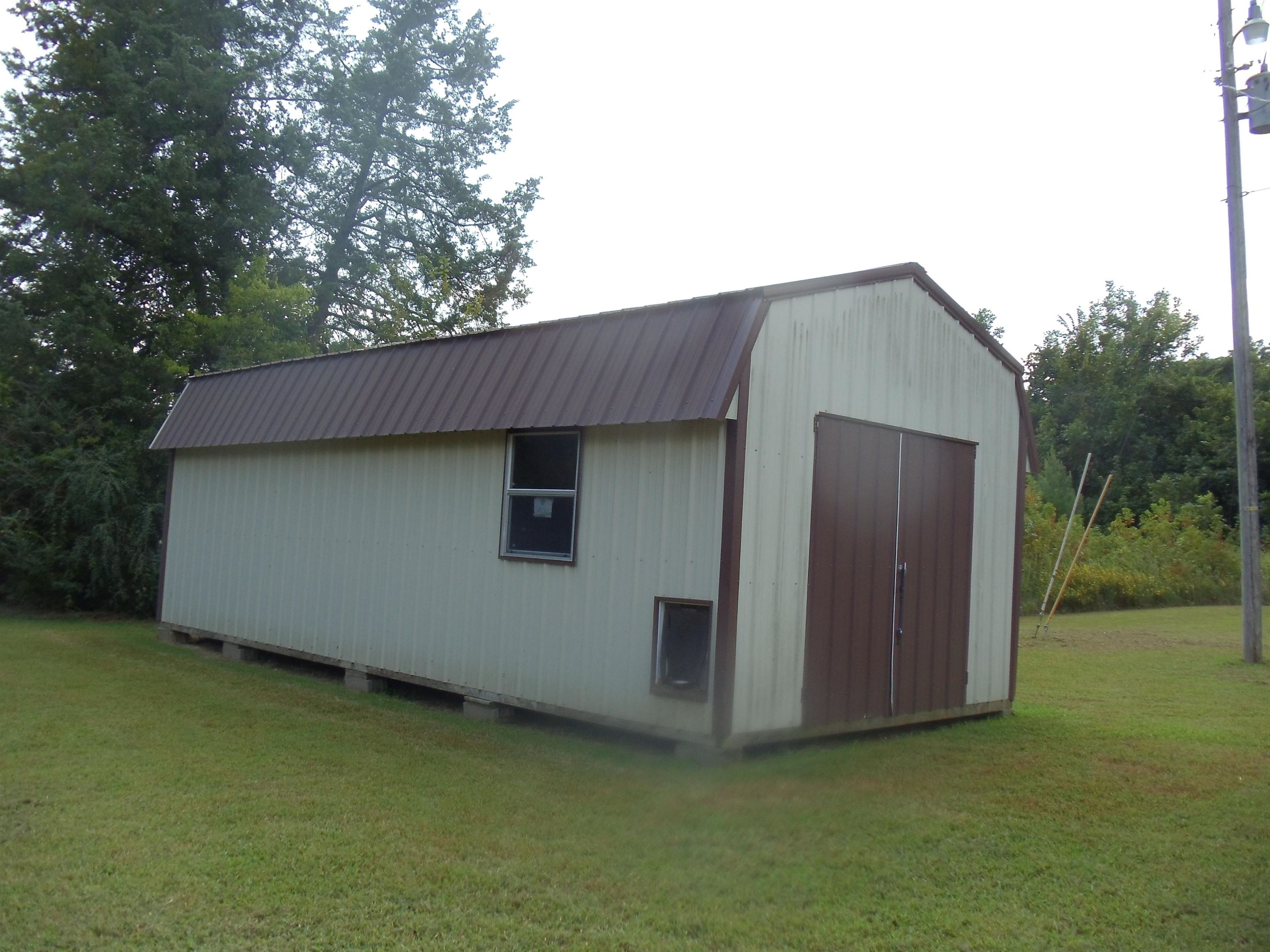 2695 Central Curve Road Ripley, TN 38063 - Photo 31 of 32 a backyard of a house with lots of green space