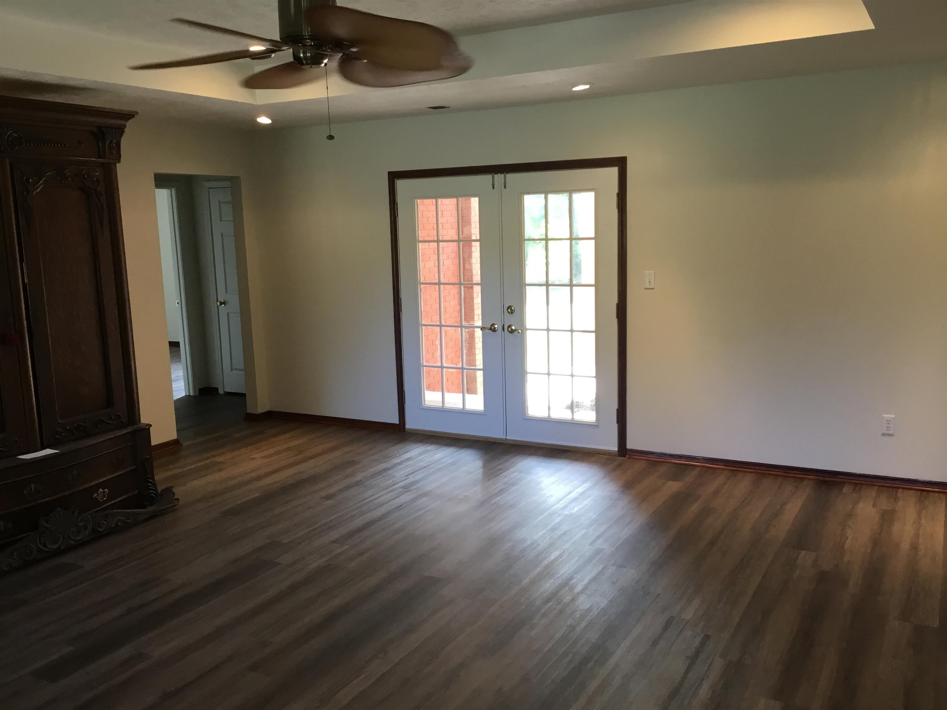 2695 Central Curve Road Ripley, TN 38063 - Photo 7 of 32 an empty room with wooden floor and windows