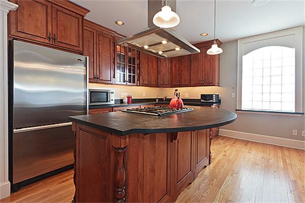 a kitchen with granite countertop a sink stainless steel appliances cabinets and a counter top space