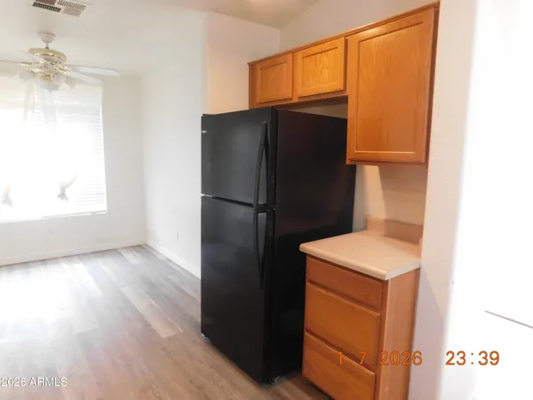 a kitchen with a refrigerator and a sink