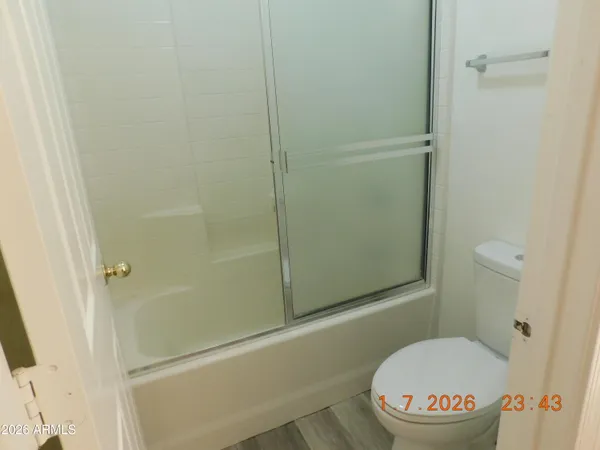 a bathroom with a toilet and a shower