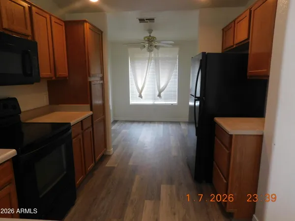 a kitchen with stainless steel appliances a refrigerator and a stove top oven