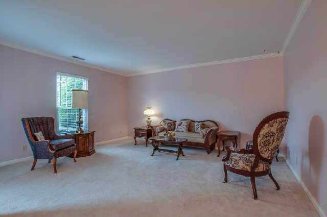 977 Gen George Patton Road Nashville, TN 37221 - Photo 3 of 18 Spacious living room with crown molding and neutral carpet.