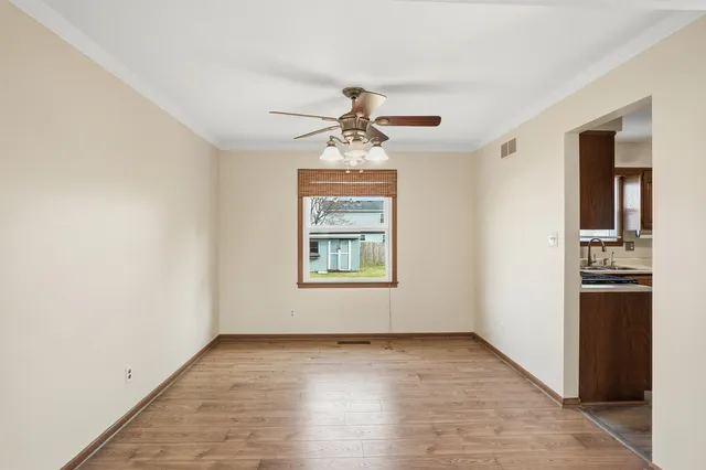 a bathroom with a toilet sink vanity and mirror