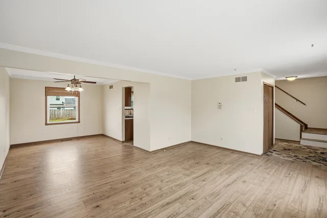an empty room with wooden floor and a window