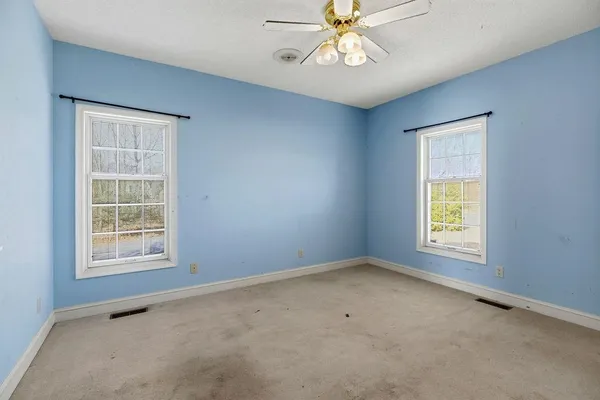 a view of an empty room with a fireplace