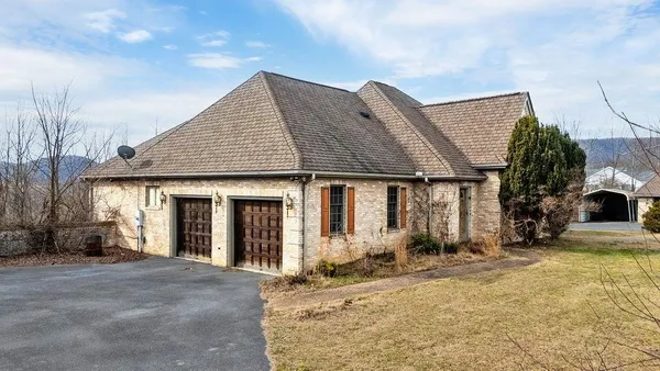 a view of a house with a yard and garage