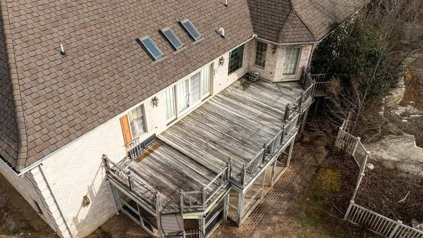 a view of roof deck with wooden fence and floor