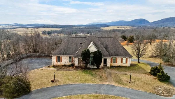 an aerial view of a house with outdoor space