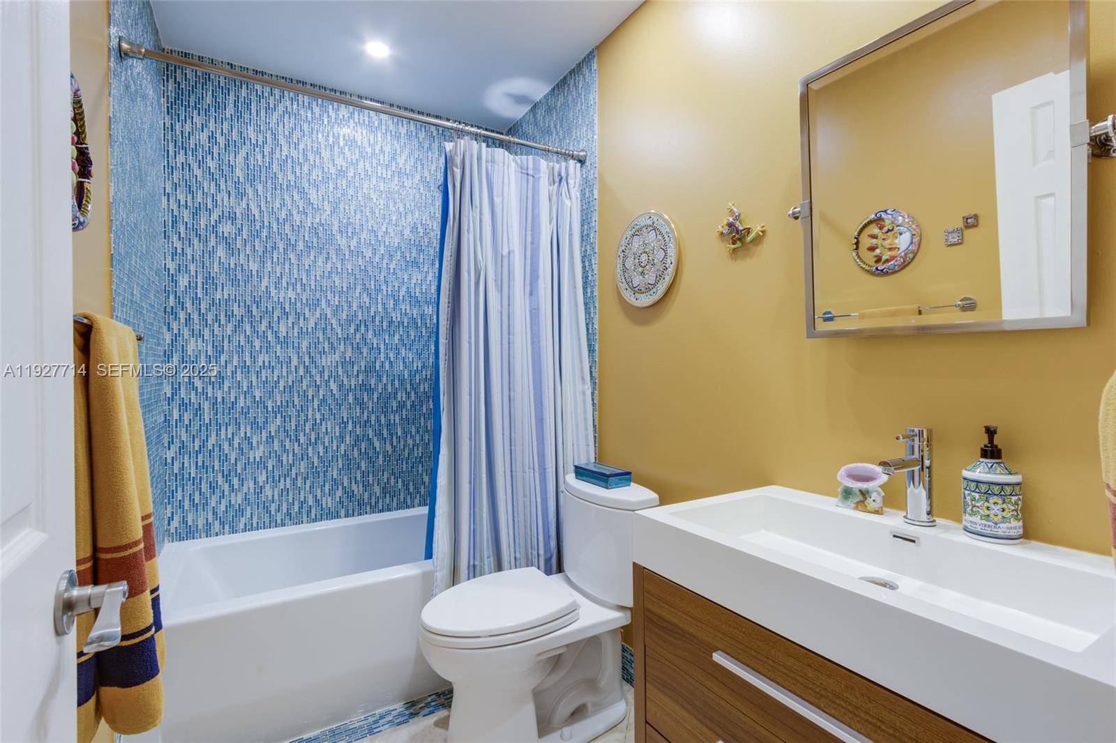 500 Bonnie Brae Way, Unit 17 Hollywood, FL 33021 - Photo 11 of 32 a bathroom with a sink a toilet and shower curtain
