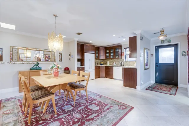 a large kitchen with a table and chairs