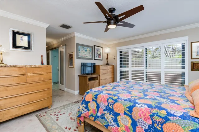 a bedroom with a bed a dresser and window