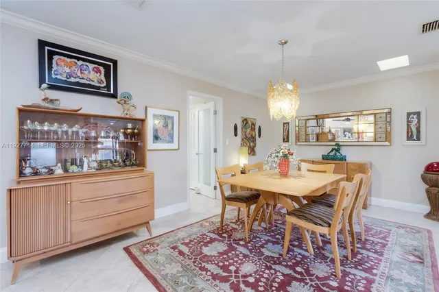 a dining room with a wooden table and chairs