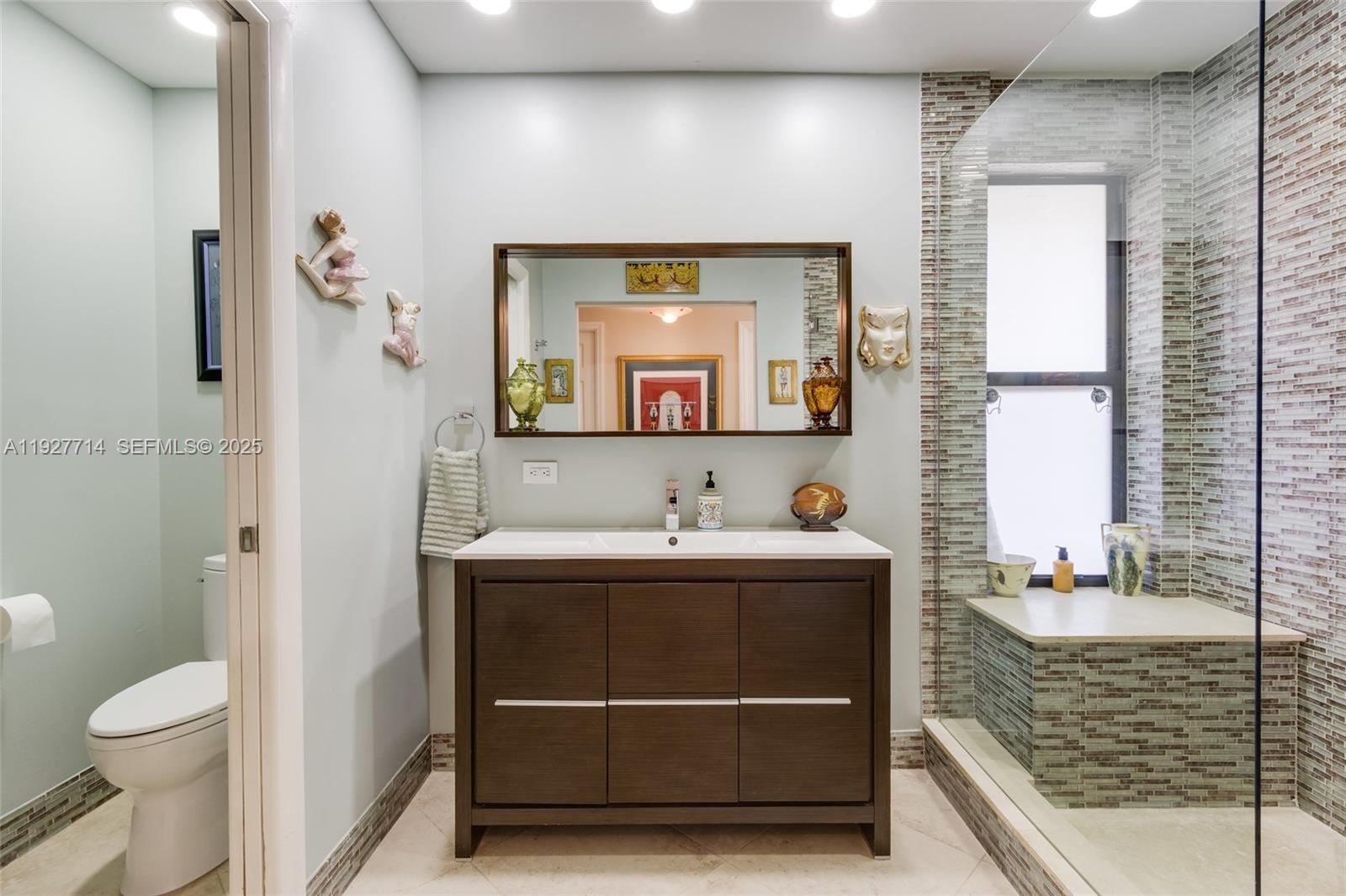 500 Bonnie Brae Way, Unit 17 Hollywood, FL 33021 - Photo 9 of 32 a bathroom with a sink a toilet and a mirror