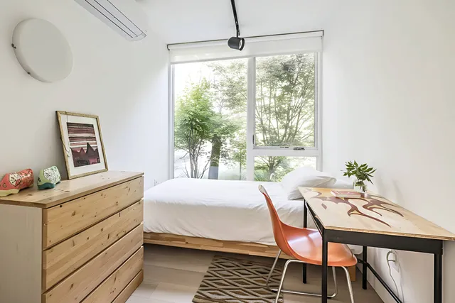 a bedroom with a bed and a table