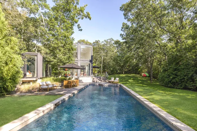 a view of a house with swimming pool and sitting area