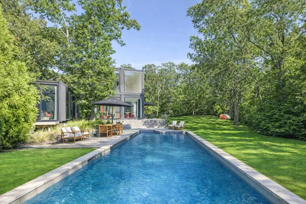 a view of a house with a yard and sitting area