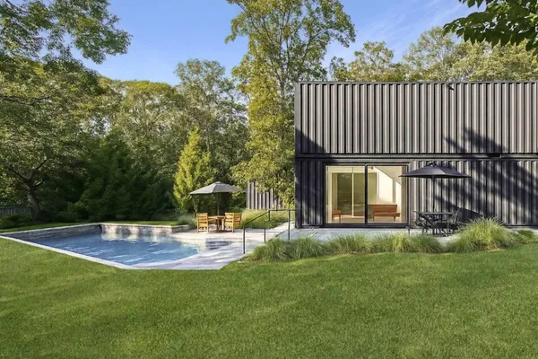 a view of a house with backyard and sitting area