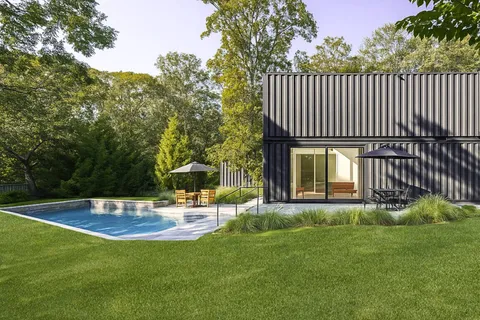a view of a house with backyard and sitting area