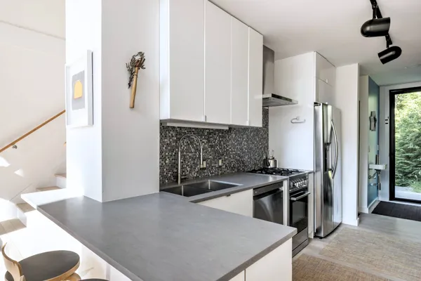 a kitchen with stainless steel appliances granite countertop a sink stove and refrigerator