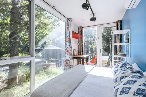 a living room filled with furniture and a large window