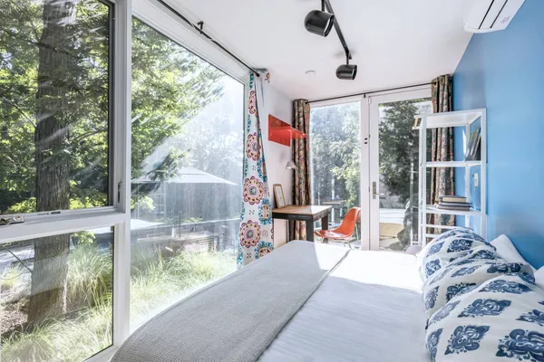 a living room filled with furniture and a large window