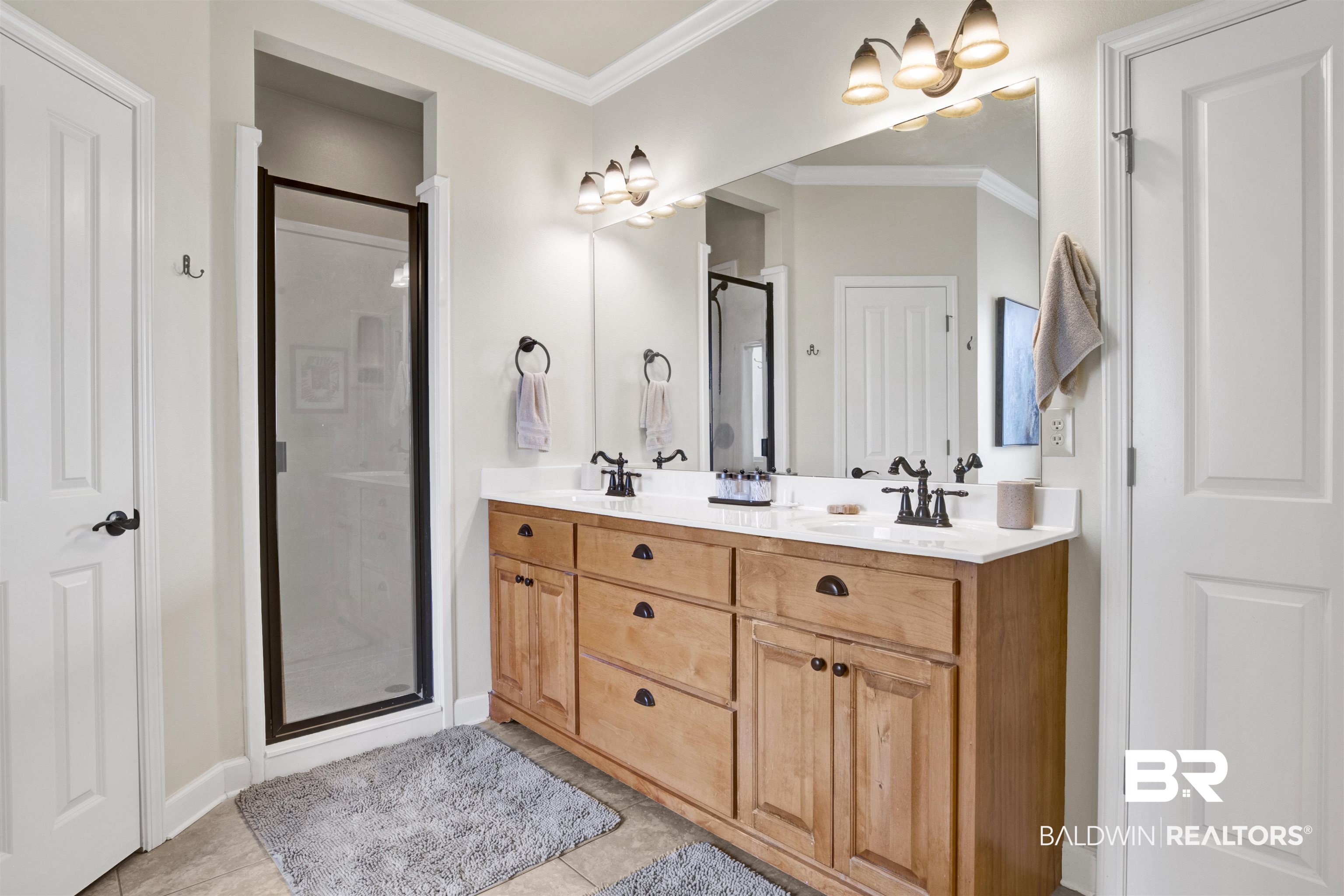 10368 Gayfer Rd Extension Fairhope, AL 36532 - Photo 23 of 43 Dual vanity featuring wood-finish cabinetry, white countertops, and integrated sinks