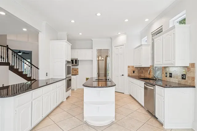 a kitchen with counter top space cabinets and stainless steel appliances