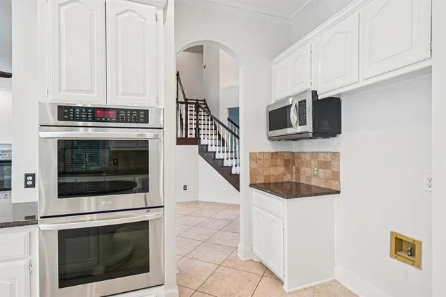 a stove top oven sitting inside of a kitchen