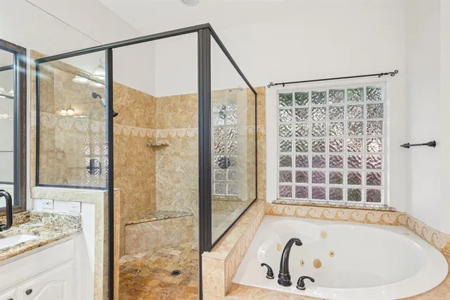 a bathroom with a bathtub and a shower