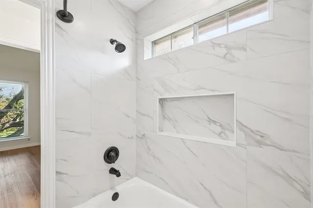 a bathroom with a glass shower door