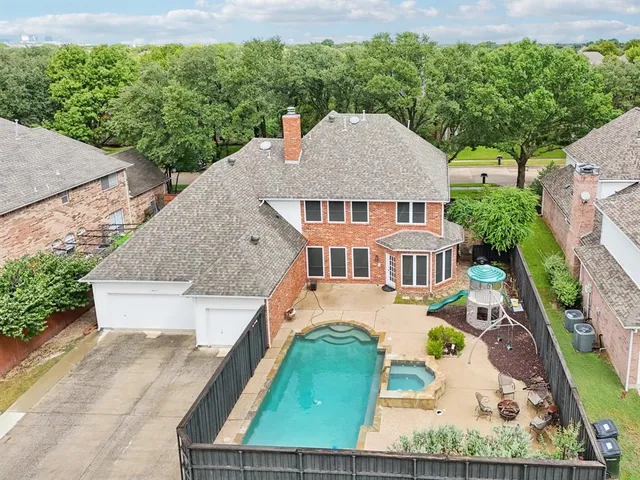 an aerial view of a house with a yard balcony