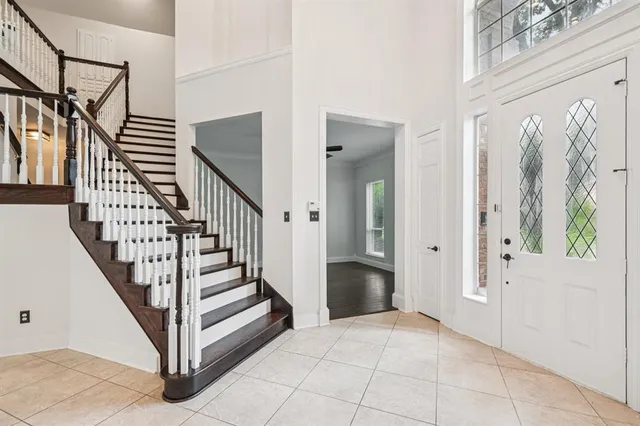 a view of entryway with wooden floor and stairs
