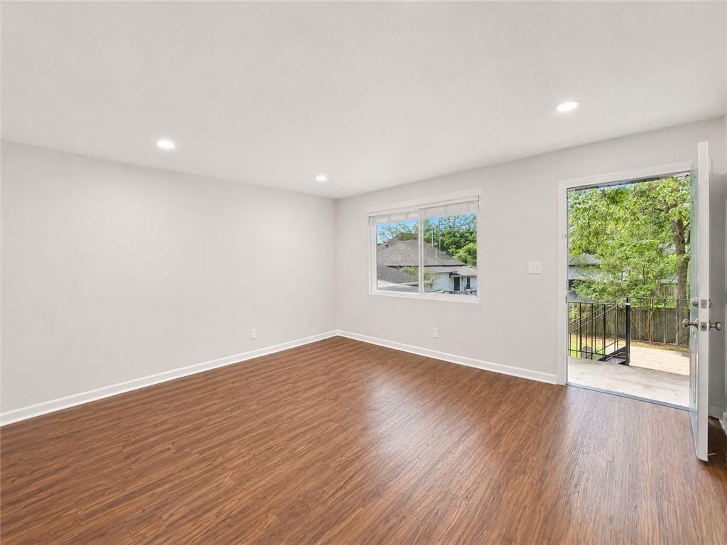 3203 East Point Street, Unit 4 Atlanta, GA 30344 - Photo 3 of 18 an empty room with wooden floor and windows