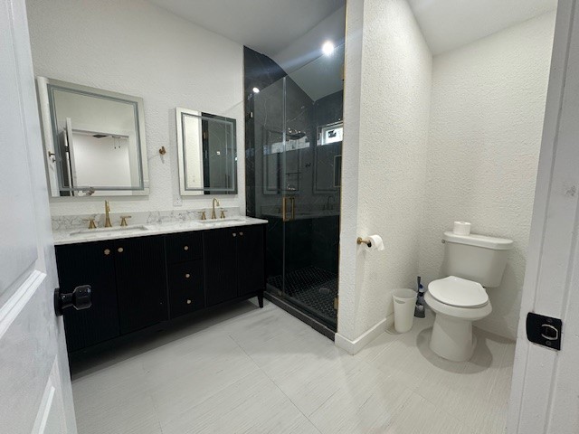 1311 East 35th Street Houston, TX 77022 - Photo 11 of 12 a bathroom with a double vanity sink toilet and mirror