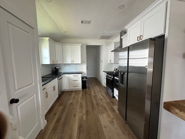1311 East 35th Street Houston, TX 77022 - Photo 6 of 12 a kitchen with a refrigerator and a sink