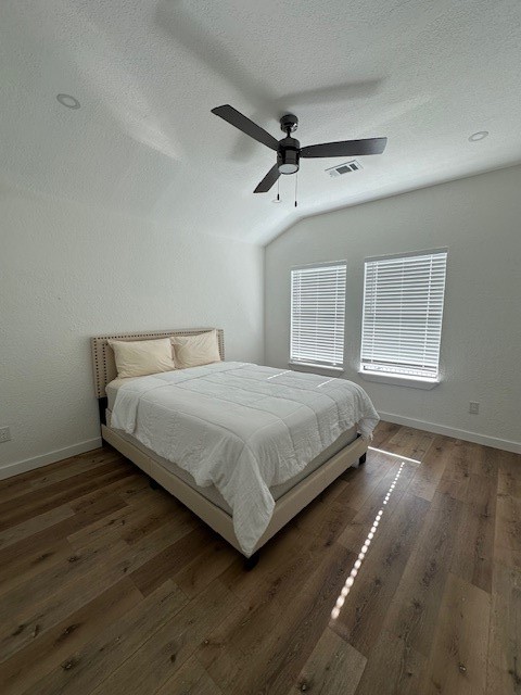 1311 East 35th Street Houston, TX 77022 - Photo 9 of 12 a bedroom with a bed and wooden floor