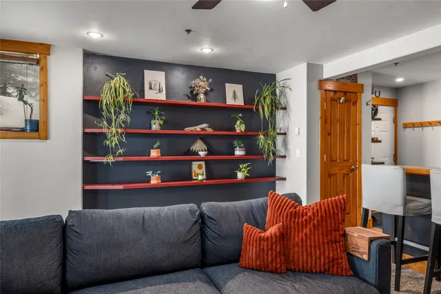 a living room with furniture cabinets and window