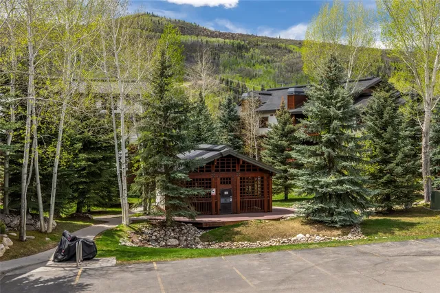 a view of a house with yard and sitting area