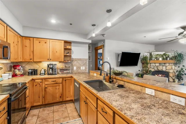 a kitchen with lots of counter top space sink and a window