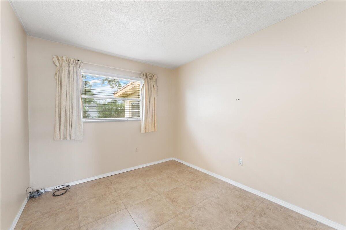 2199 Fatzler Road Melbourne, FL 32935 - Photo 17 of 23 an empty room with windows