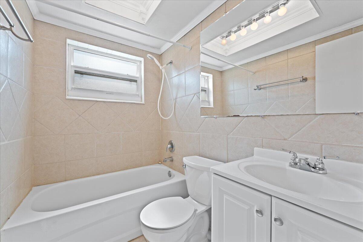2199 Fatzler Road Melbourne, FL 32935 - Photo 19 of 23 a bathroom with a sink a toilet and bathtub