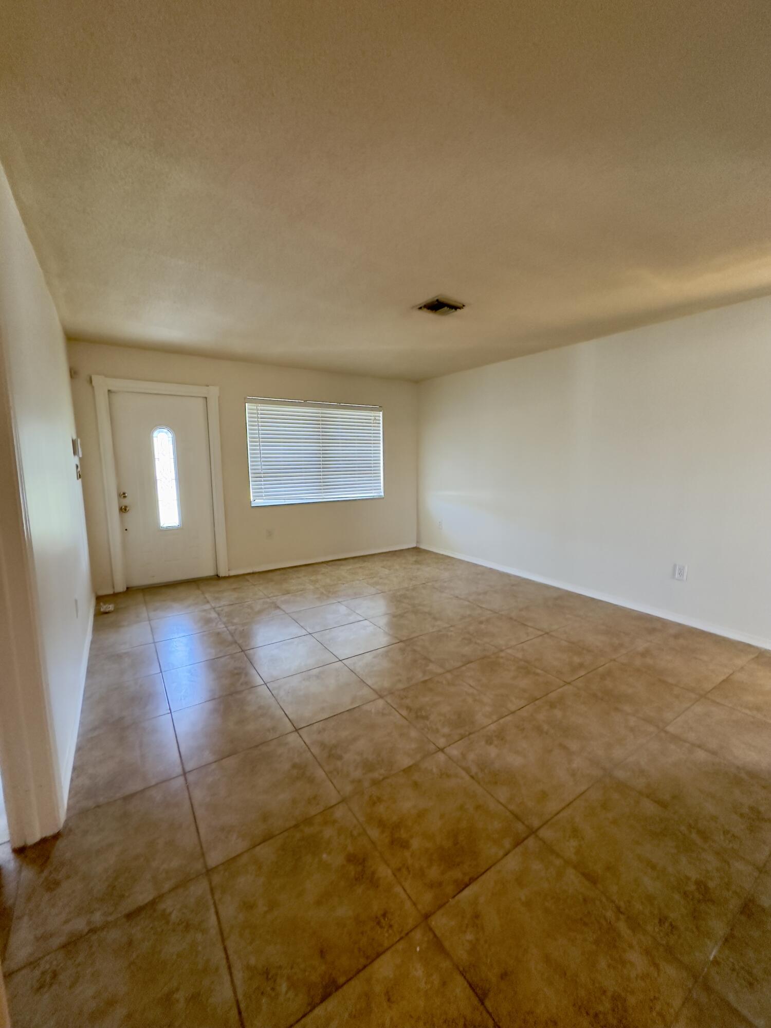 2199 Fatzler Road Melbourne, FL 32935 - Photo 5 of 23 an empty room with wooden floor and windows