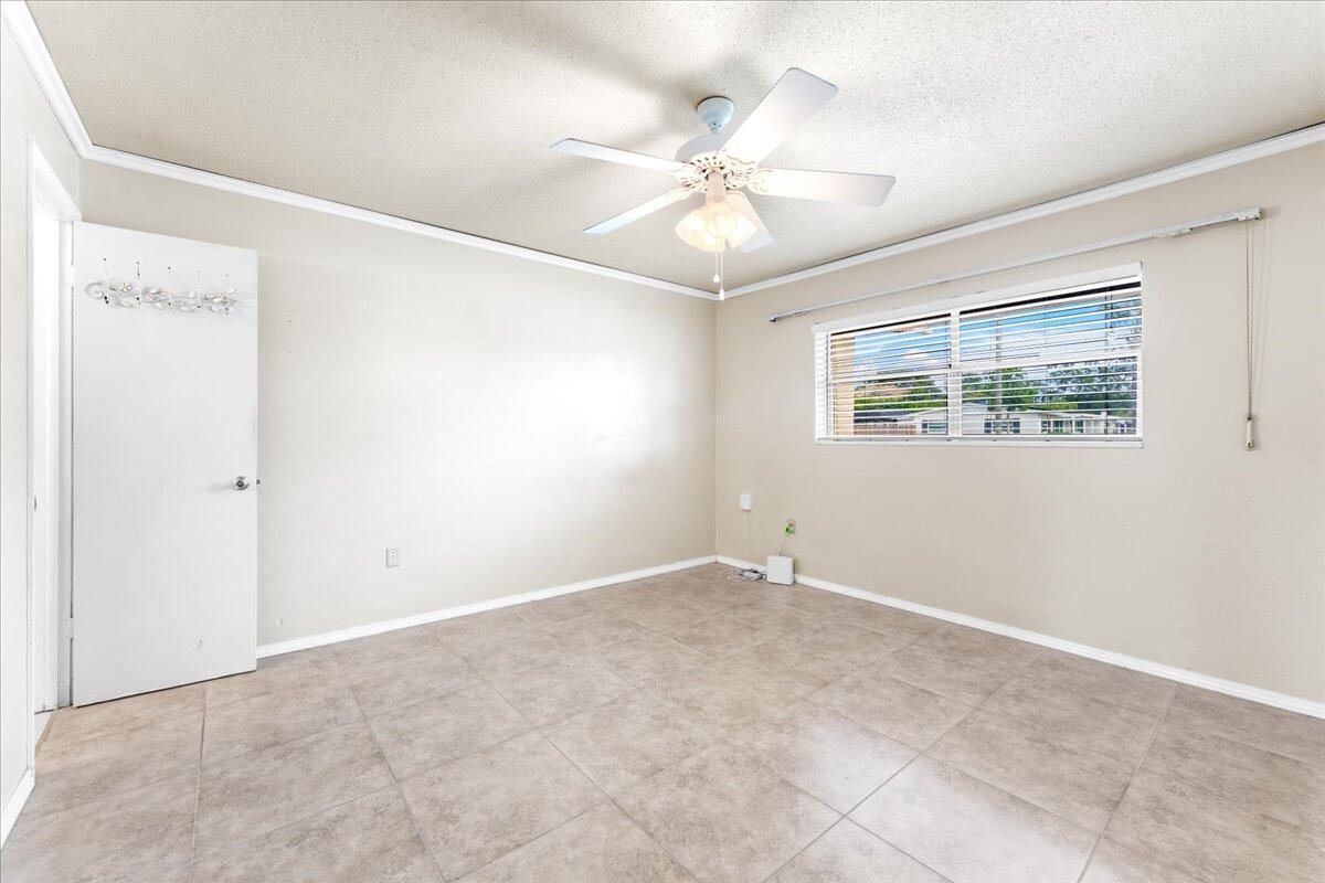 2199 Fatzler Road Melbourne, FL 32935 - Photo 7 of 23 a view of an empty room with a window