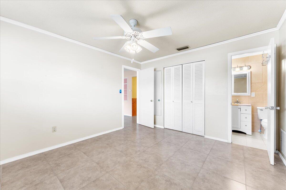 2199 Fatzler Road Melbourne, FL 32935 - Photo 8 of 23 an empty room with fan and entryway