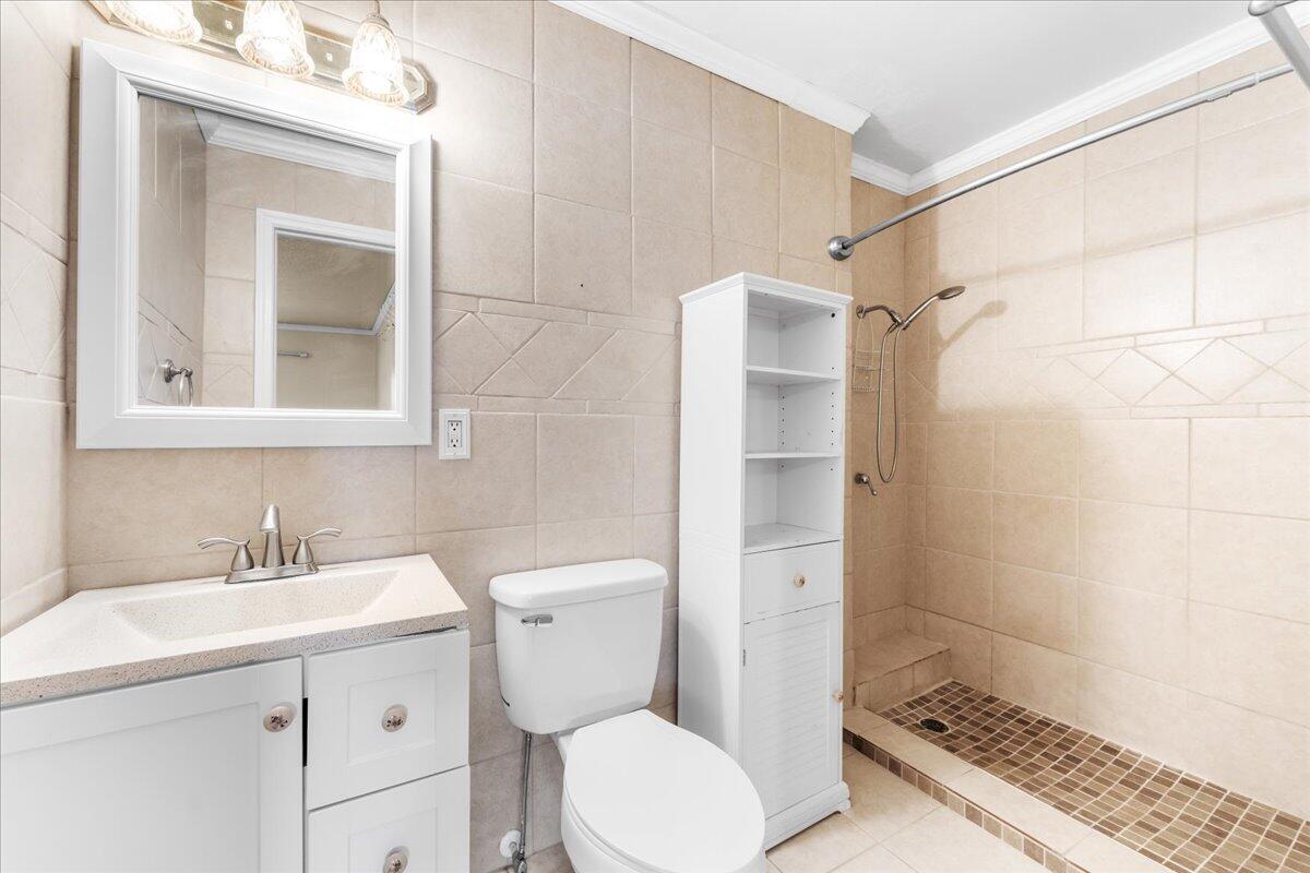 2199 Fatzler Road Melbourne, FL 32935 - Photo 9 of 23 a bathroom with a sink toilet and shower