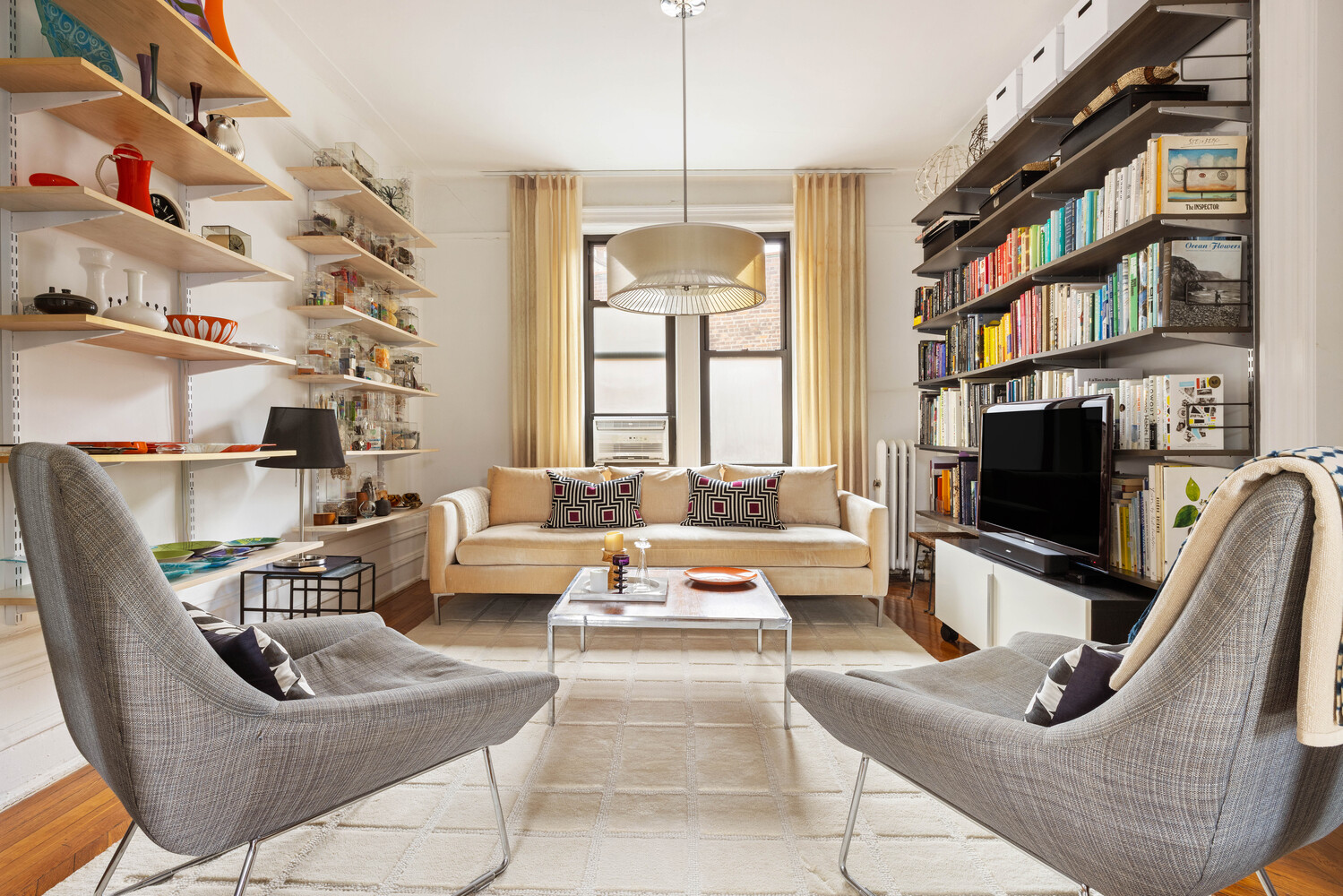 21 Butler Place, Unit 4E Brooklyn, NY 11238 - Photo 2 of 11 a living room with furniture a flat screen tv and a large window