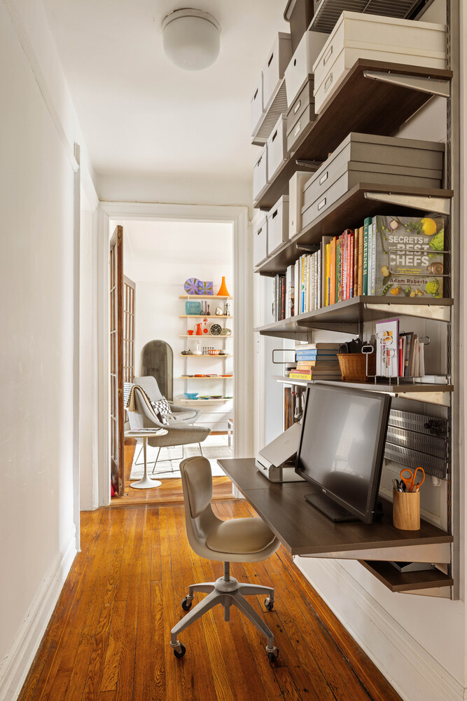 21 Butler Place, Unit 4E Brooklyn, NY 11238 - Photo 6 of 11 a view of a workspace with furniture and a book shelf