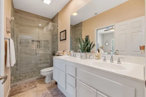 a bathroom with a sink toilet and shower