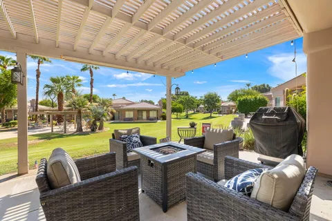 a view of a patio with table and chairs with wooden fence and plants